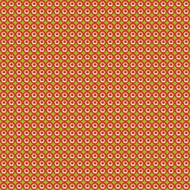 Pattern of repeating red sun on a green stock photo