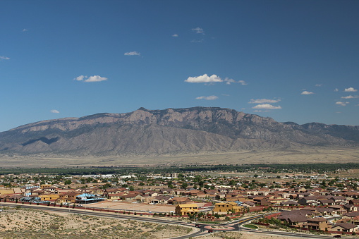View of Sandia Mountain with the expanding sprawl of Albuquerque's suburb of Rio Rancho in the foreground.  