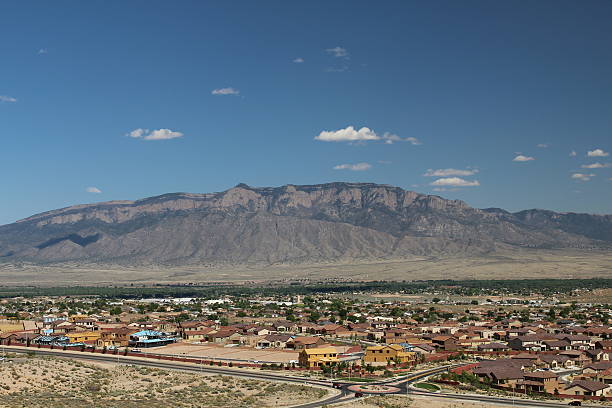 Sandia Mountains with suburbs View of Sandia Mountain with the expanding sprawl of Albuquerque's suburb of Rio Rancho in the foreground.   bernalillo county stock pictures, royalty-free photos & images