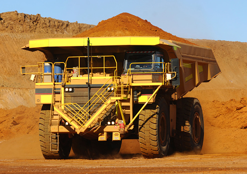 A large haul truck carrying a load of crushed rock and ore on a minesite.