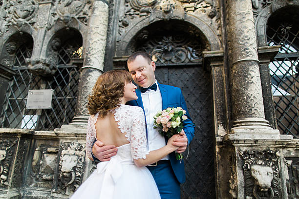 istock Sensual newlywed couple hugging near old building with columns 531189736