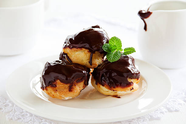 istock profiteroles with cream and chocolate sauce. 531189761