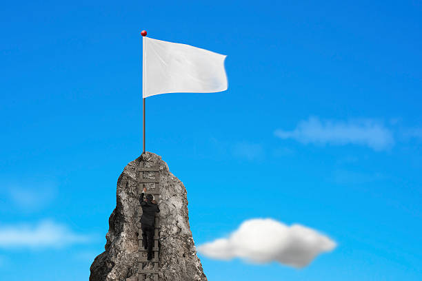 istock Businessman climbing on peak with blank white flag and sky 531189819