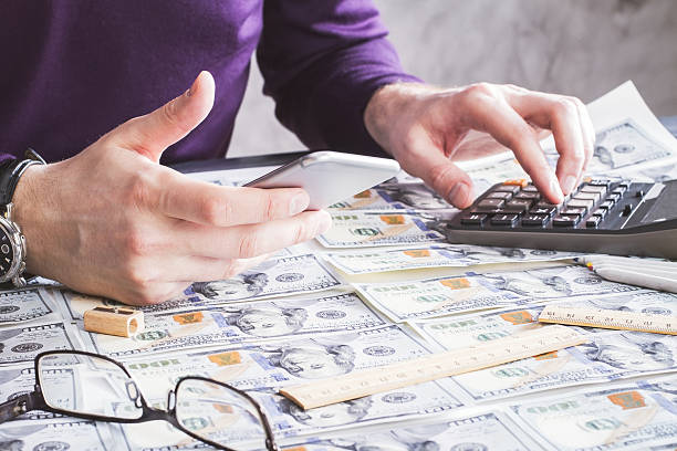 istock Man counting on money closeup 531190316
