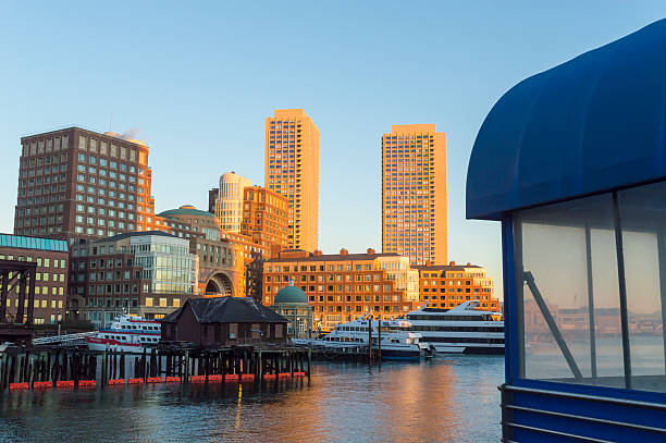 Rowes Wharf skyline Boston, Massachusetts, USA  - January 28, 2016: View of Rowes Wharf from Boston Harborwalk just after dawn harborwalk stock pictures, royalty-free photos & images