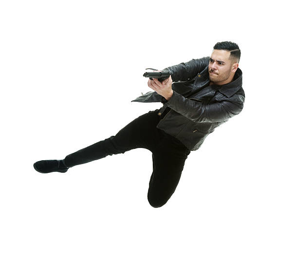 istock Casual man jumping with handgun 531191786
