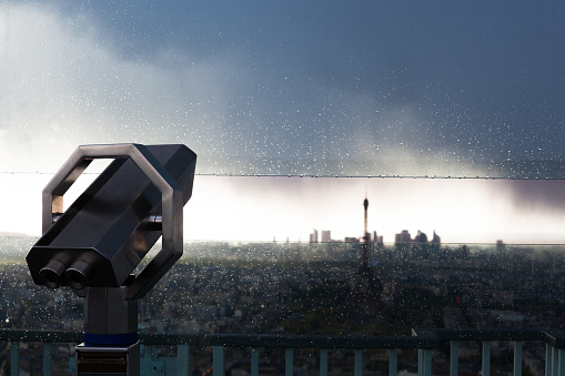 dusk view of telescope Eiffel Tower and La Defense Paris - rainy evening