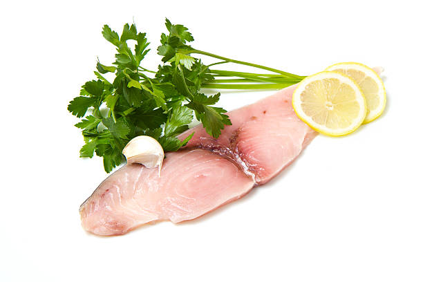 istock swordfish with lemon and parsley on white 531193392