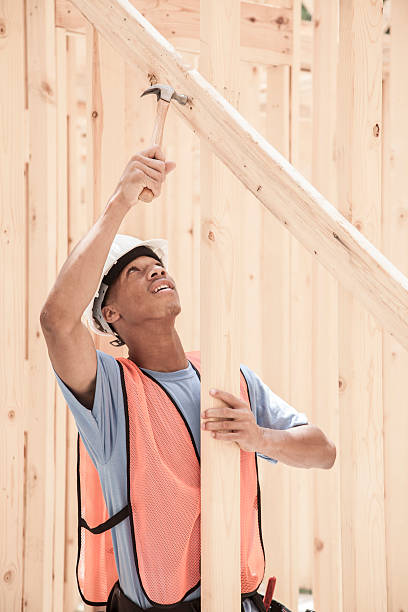 istock Construction worker busy working at job site. Framed building. Safety. 531193914