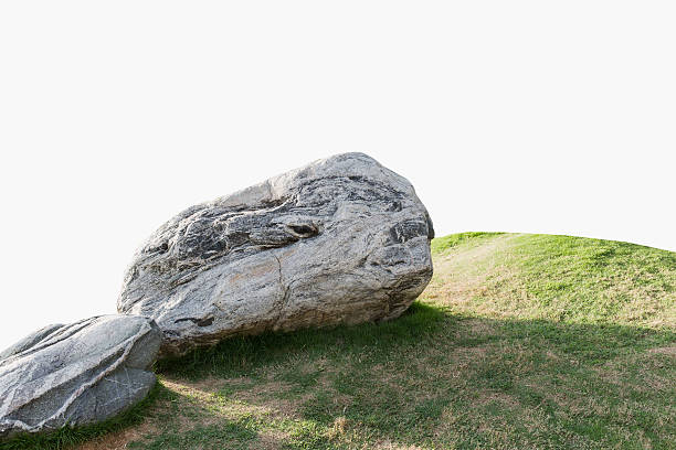 Huge stone and meadow isolated on white