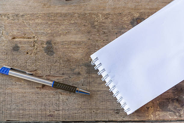 istock paper note and pen on wood background 531195628