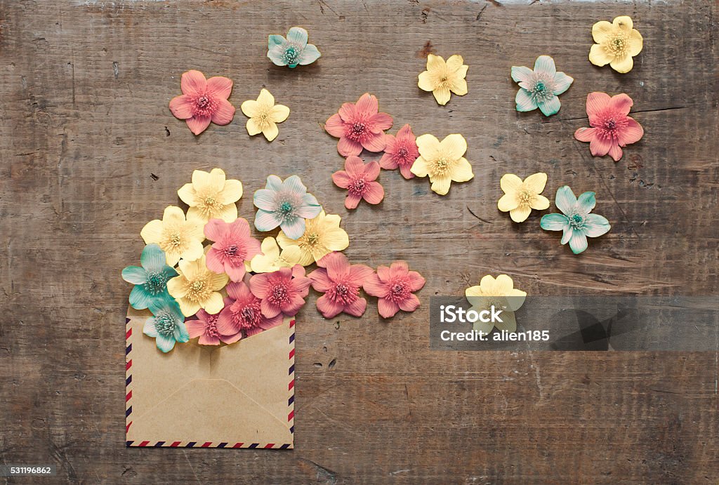 beautiful flowers in the old envelope beautiful flowers in the old envelope on wooden table Invitation Stock Photo