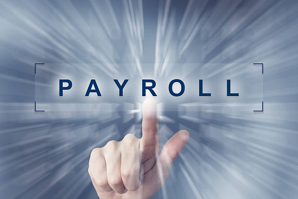 hand clicking on financial payroll button stock photo