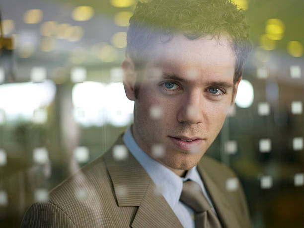 istock Young businessman standing behind glass pane 531213095