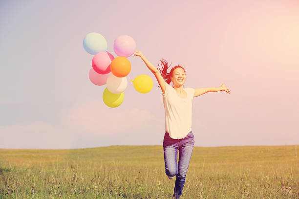 istock young asian woman  with colored balloons 531213143