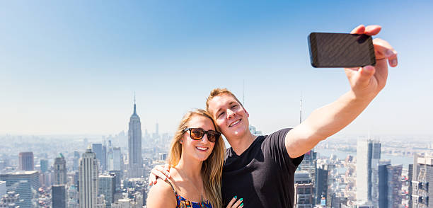 istock Young Couple Taking Selfie with New York on Background 531214497