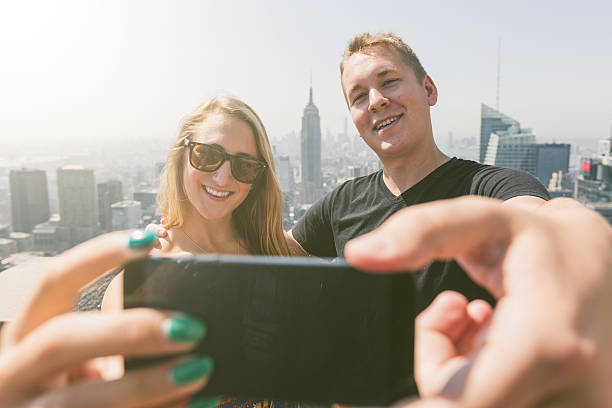 istock Young Couple Taking Selfie with New York on Background 531214589