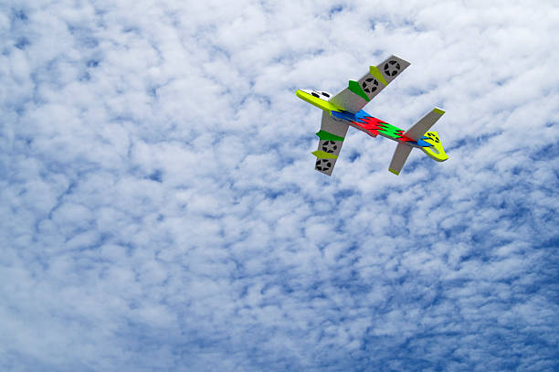 istock colorful toy plane against blue sky. 531223681
