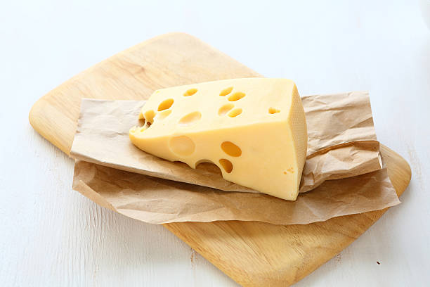 istock Piece of cheese on a board 531224245