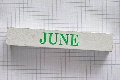 June month printed on wooden block.