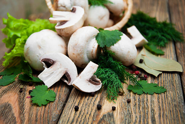 Mushroom mushrooms Champignon mushrooms in basket,herbs and spices on a wooden background crimini mushroom stock pictures, royalty-free photos & images