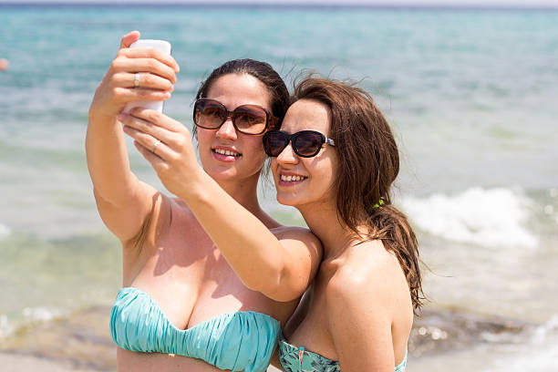istock two young beautiful girls taking selfie 531225619