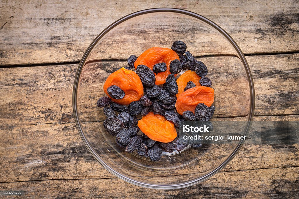 Healthy food background. Dried fruits on wood table Healthy food background. Dried fruits on wood table. Top view of Apricots and raisins 2015 Stock Photo