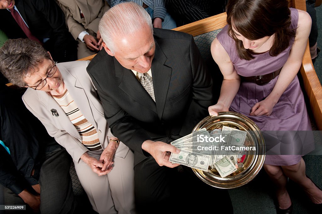 Tithe and offering Tithes and offering during a church service. Giving Stock Photo