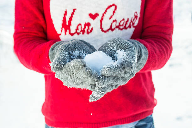 istock Girl playing with snow in red pullover and gloves 531228539