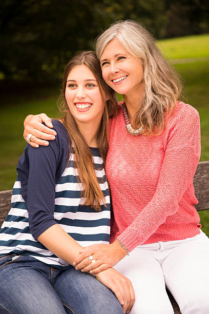 istock Mother and Daughter Sit In Park Together 531228705