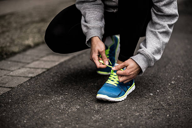 istock Runner Tying Shoelaces In The Road 531228721