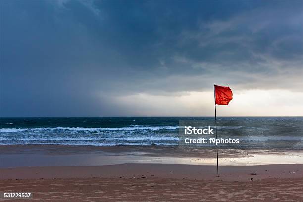 Storm Warning Flags On Beach Baga Goa India Stock Photo - Download Image Now - Red, Warning Sign, Flag