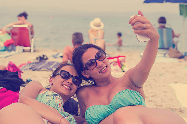 istock two young beautiful girls taking selfie 531229947