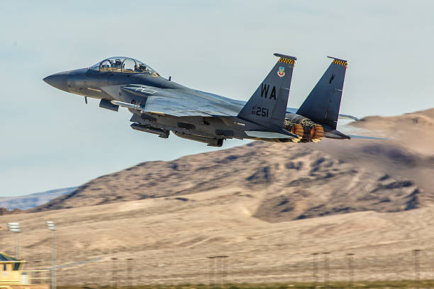 F-15 Eagle performs flyby during Aviation Nation at Nellis AFB Las Vegas, USA - November 9, 2014: F-15 Eagle performs flyby during Aviation Nation airshow at Nellis AFB on November 9,2014 in Las Vegas,NV. F-15 is a tactical fighter. It was designed by McDonnell Douglas.  supersonic airplane editorial airplane air vehicle stock pictures, royalty-free photos & images