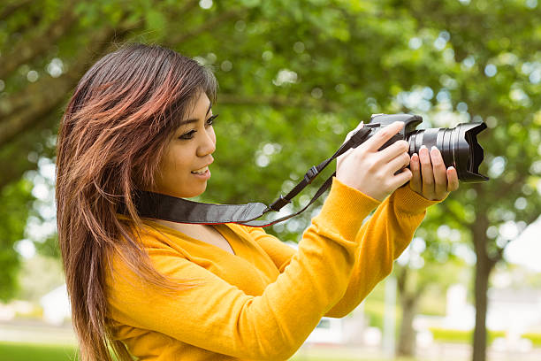 istock Beautiful female photographer at park 531231269