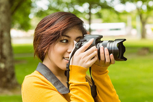 istock Beautiful female photographer at park 531231271