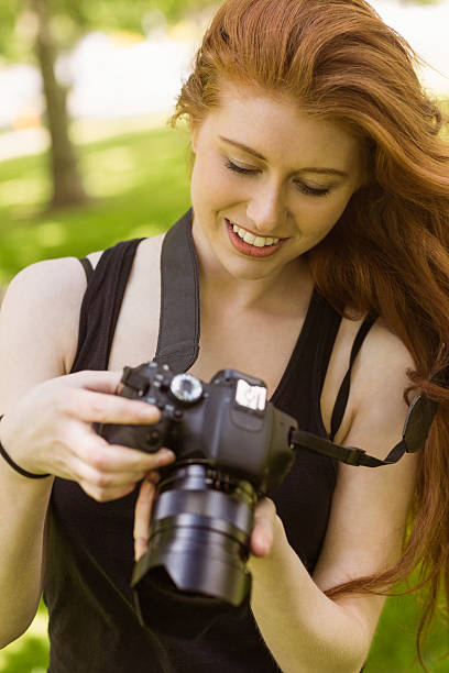 istock Beautiful female photographer at park 531236779
