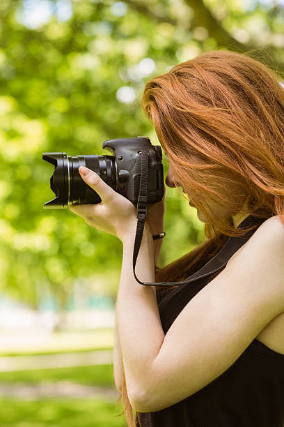 istock Beautiful female photographer at park 531236847