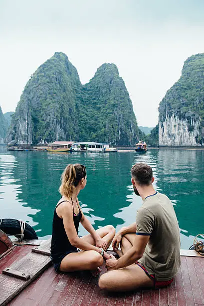 Photo of Couple hugging on cruise ship, view on Ha long Bay