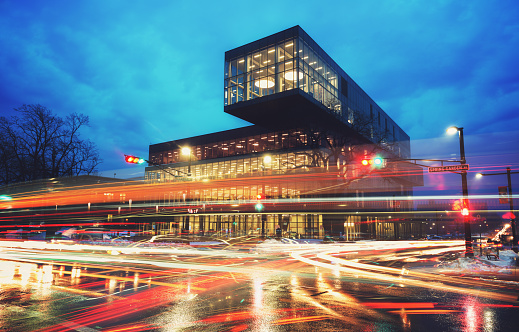 A blur of motion at the intersection of Spring Garden and Queen streets in front of the newly completed Halifax Central Public Library.  Long exposure in twilight.