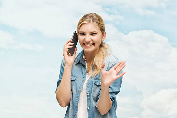 istock Smiling woman on phone and waving hand 531238580
