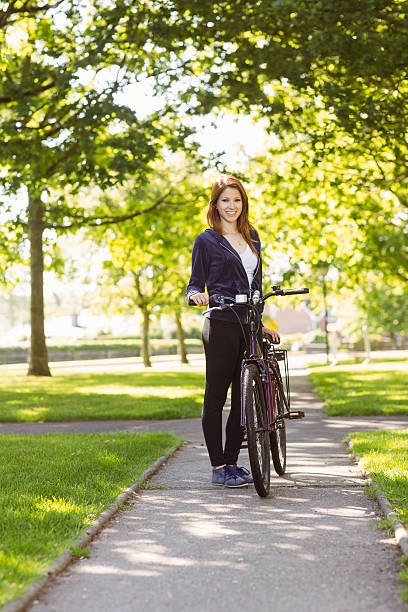 istock Pretty redhead with her bike 531239003