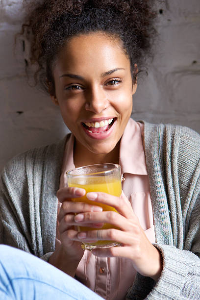 istock Young woman enjoying her fruit juice drink 531239675