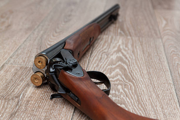 istock retro gun with shotgun shells on wooden 531239812