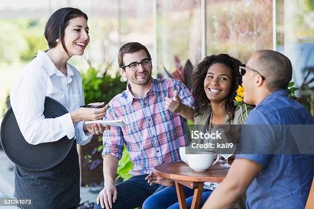 Waitress At Sidewalk Cafe With Customers Stock Photo - Download Image Now - Waiter, Ordering, Waitress