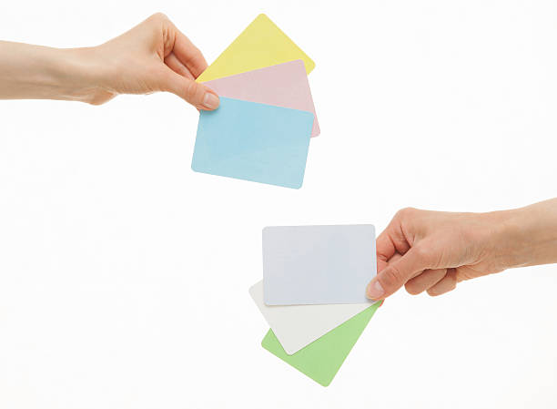 istock Two hands holding colorful paper cards 531241092