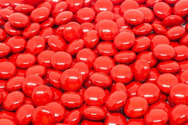 istock red sugar coated pills tablets vitamin on white background 531241142