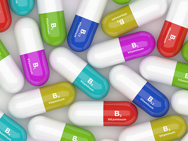 Vitamin B pills lying on desk stock photo