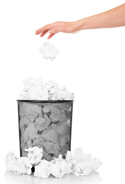 istock Hand throwing crumpled paper into office trash isolated on white 531242652