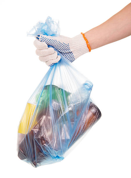 istock Hand holds garbage bag with household waste isolated on white 531242718